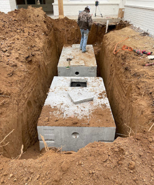 A man standing in a hole in the ground